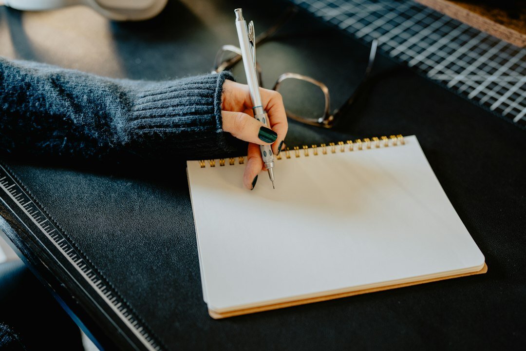 mystery writer at desk with notebook