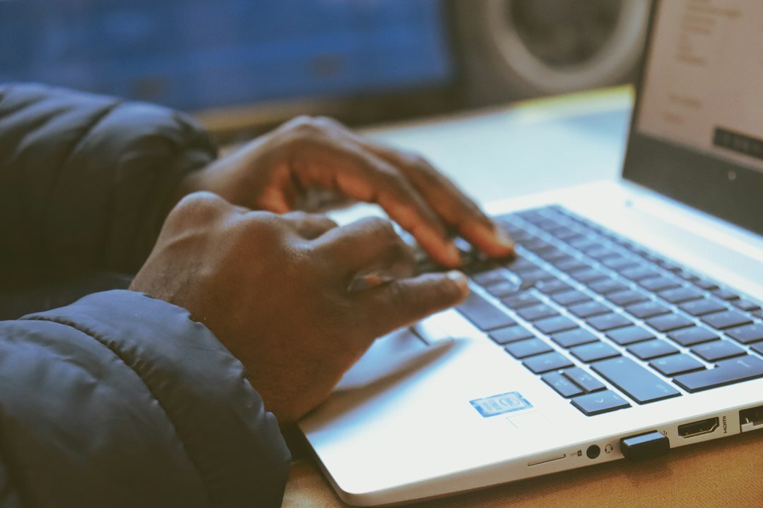 mystery writer typing on laptop